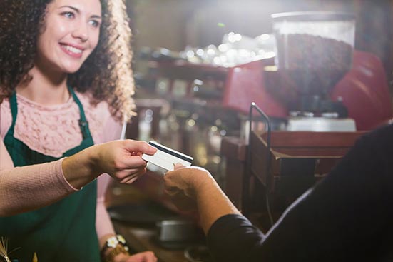 Person paying with credit card at shop