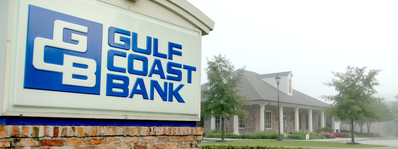 Gulf Coast Bank sign in front of the Ambassador Caffery at Dover branch